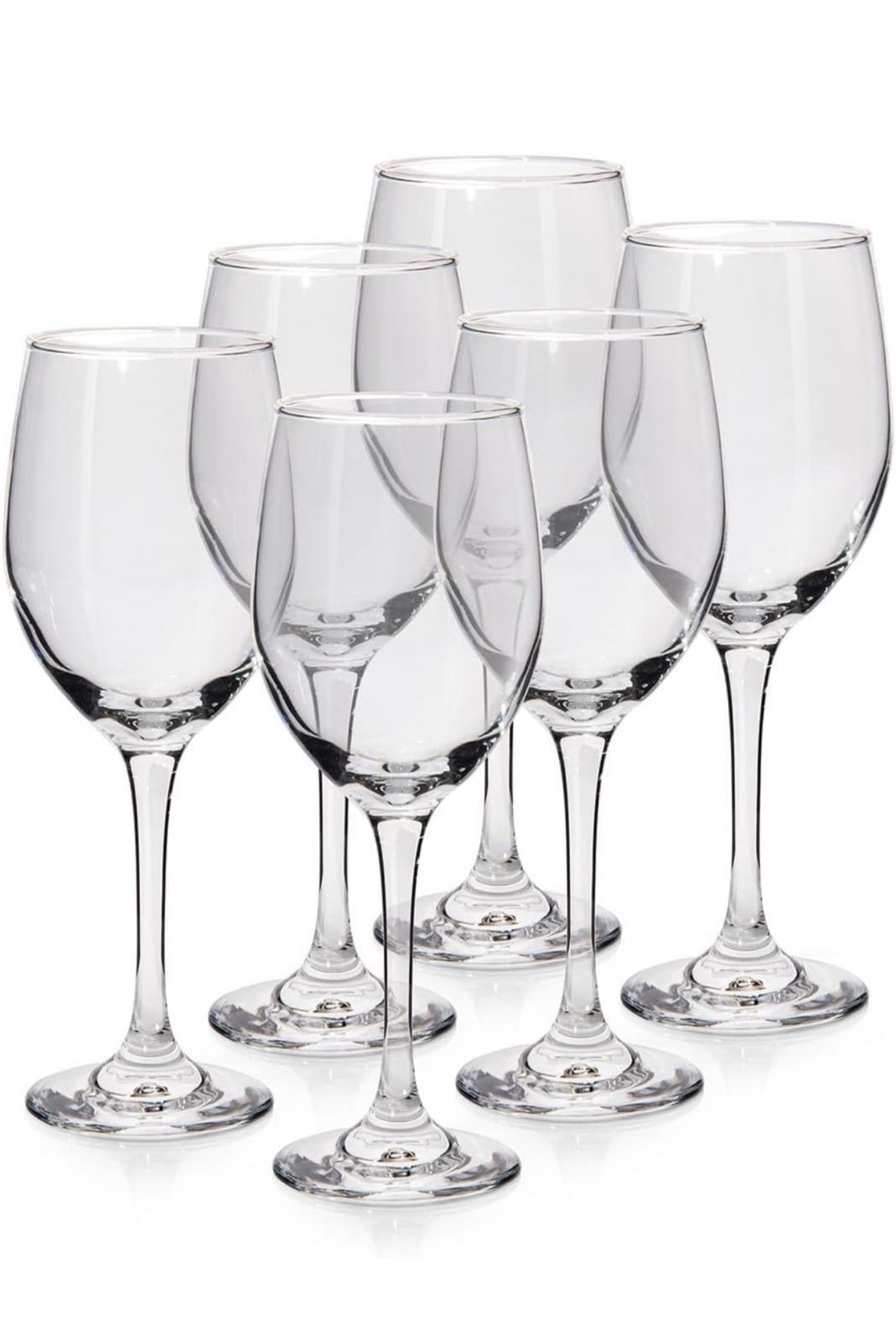 Set of six clear wine glasses with elegant stems, arranged closely together.