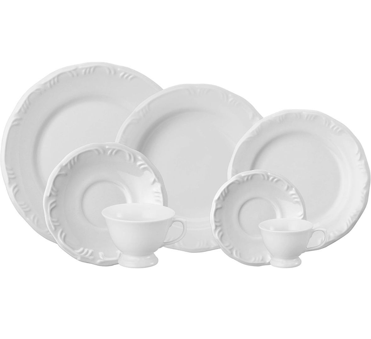 Set of white porcelain dinnerware with elegant, embossed rim design, including plates and cups.